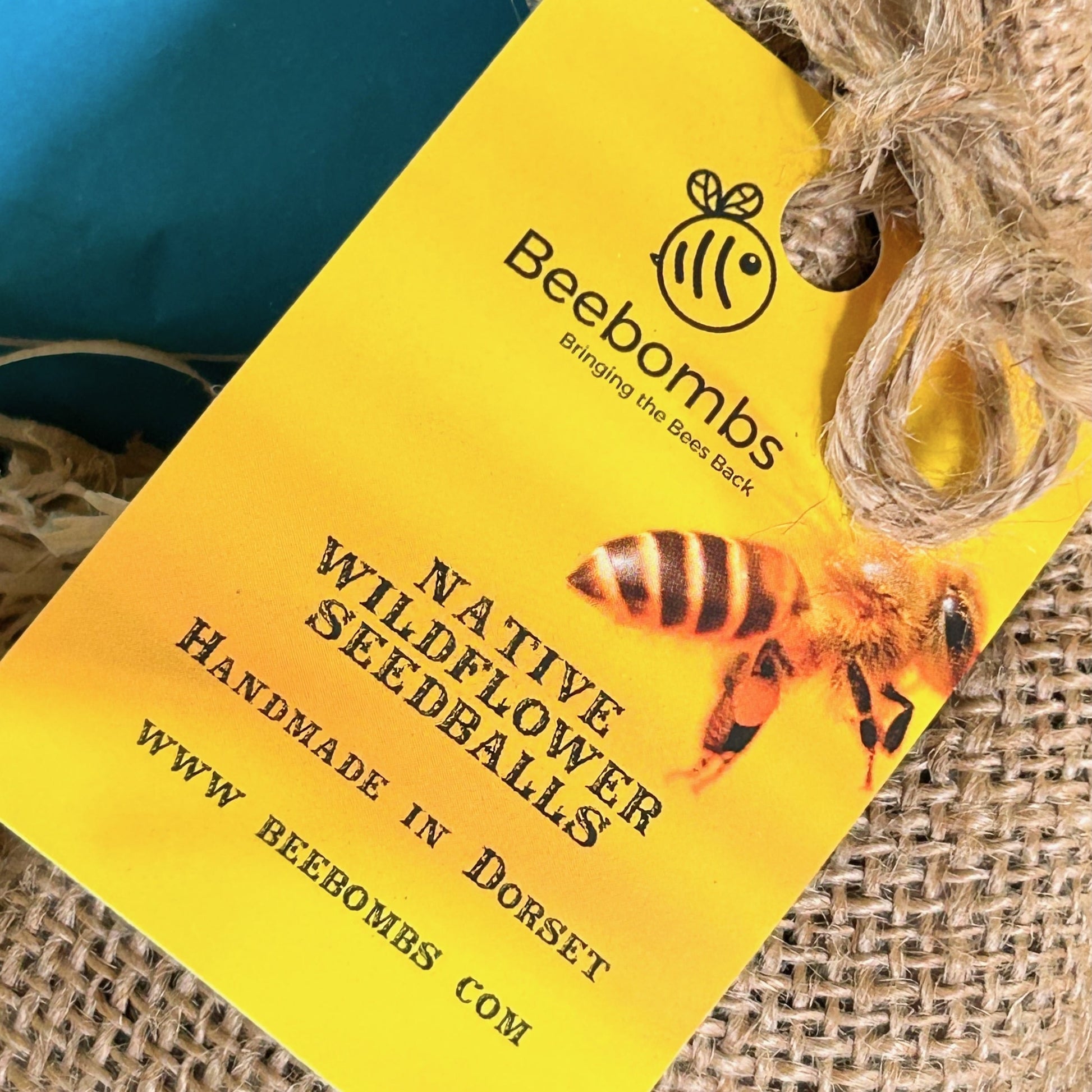 Gardener's gift  hamper with 'Gardener's Hand Scrub', 'Gardeners Soap', and 'Camomile & Elderflower' tea in a box as well as Beebombs wild flower seeds to create a wild flower meadow.