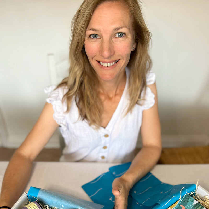 Sand and Sparkle Gift Box founder packing gift boxes