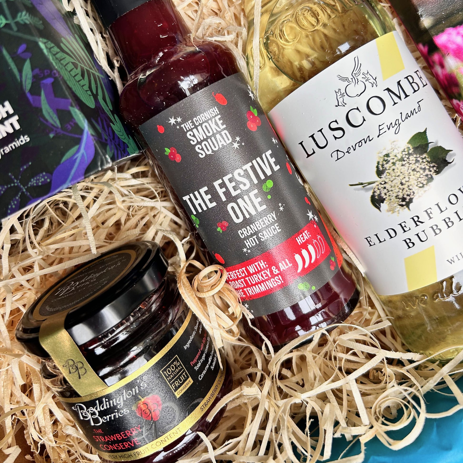 Christmas Gift Hamper packed with Devon and Cornish products including hot cranberry sauce, elderflower bubbly, kernow chocolate, Cornish jam, Exmoor tea - sustainable christmas hamper
