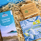cornish coastal letterbox gift set with illustrated coaster, artisan chocolate and handcrafted soap