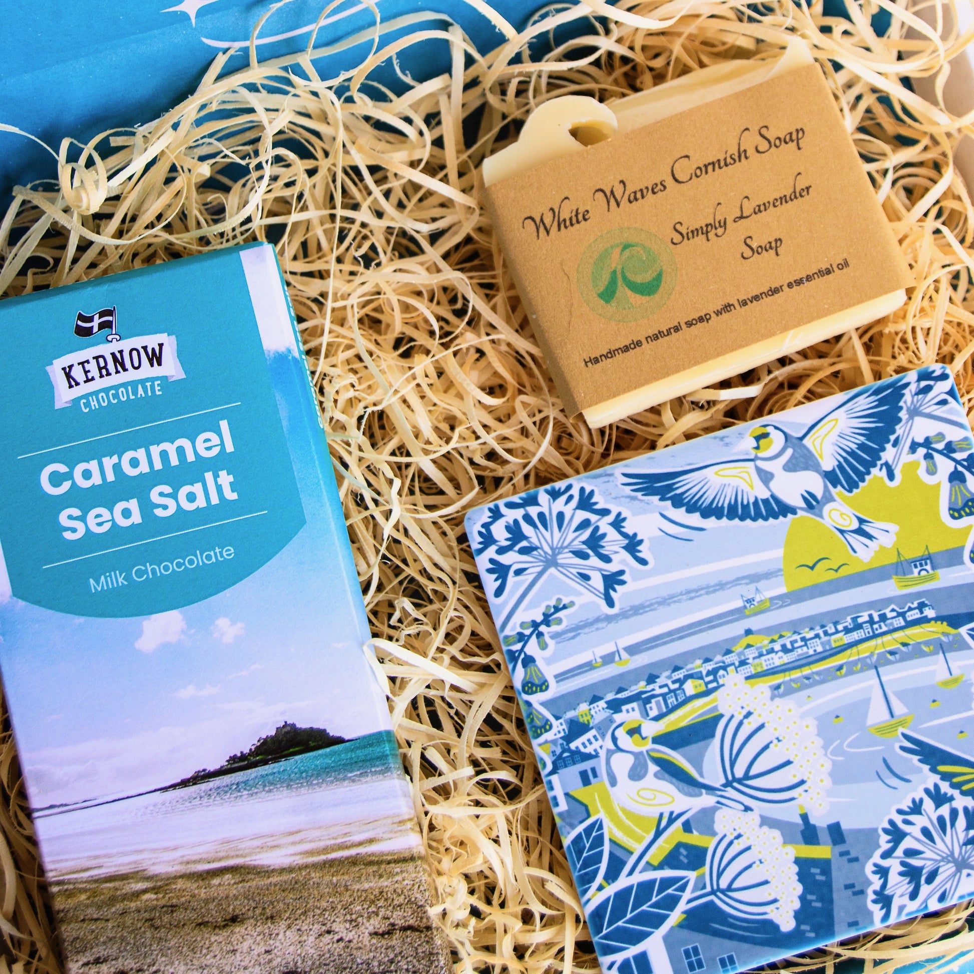 cornish coastal letterbox gift set with illustrated coaster, artisan chocolate and handcrafted soap