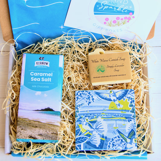 Cornish Coastal Letterbox Gift Set with illustrated Cornish coaster from Jennifer Armitage, Kernow Chocolate and White Waves Cornish Soap. IN coastal themed letterbox with gift card.